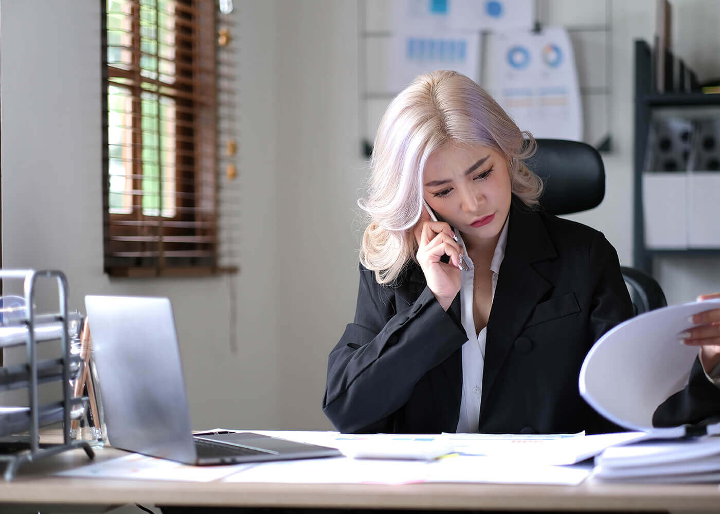 CFO reading document while speaking on the phone